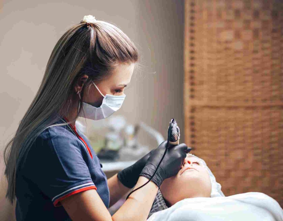 A skilled skincare provider performing a tailored facial treatment in Coral Gables