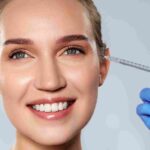 Licensed practitioner evaluating forehead muscle movement during a Botox consultation in Coral Gables