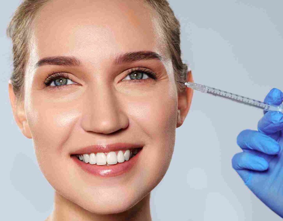 Licensed practitioner evaluating forehead muscle movement during a Botox consultation in Coral Gables