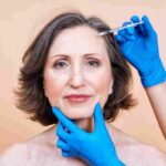 Licensed medical professional conducting a facial consultation at a boutique aesthetic clinic in Coral Gables.
