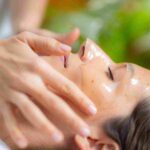 Client receiving a relaxing professional facial treatment at a boutique aesthetic clinic in Coral Gables.
