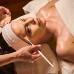 An aesthetician performing a customized facial treatment in Coral Gables