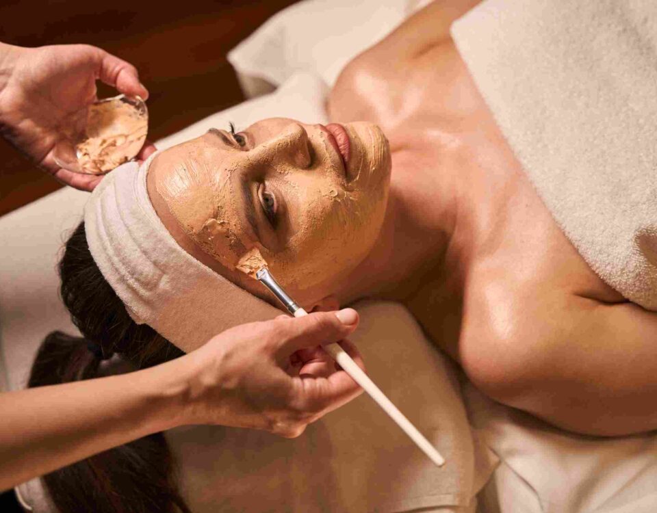 An aesthetician performing a customized facial treatment in Coral Gables